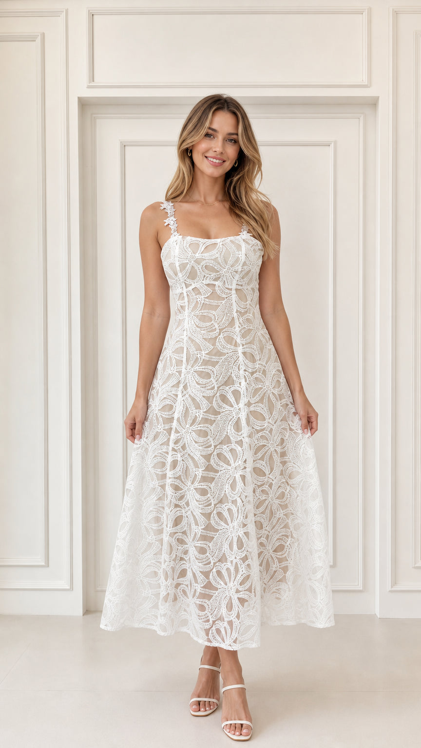 Front view of woman wearing white floral embroidered lace A-line midi dress with applique straps