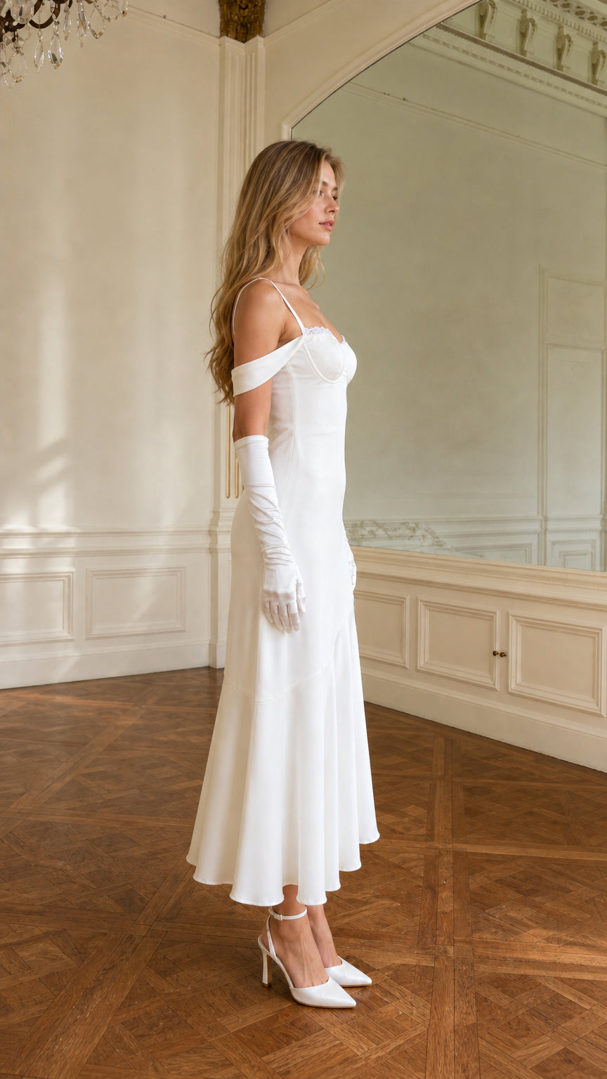 Side profile of model wearing white satin sweetheart midi dress