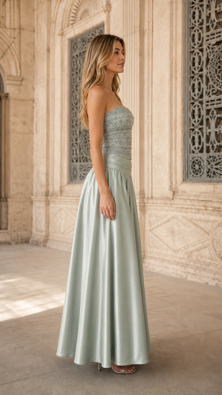 Side angle of model wearing sage green embellished A-line formal dress