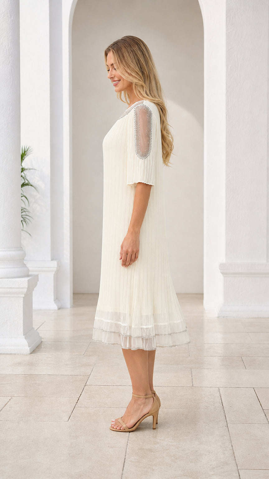 Side profile of cream pleated midi dress with sheer embellished sleeves
