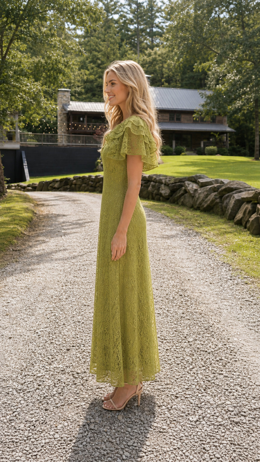 Side profile of model wearing olive green lace maxi dress on gravel path