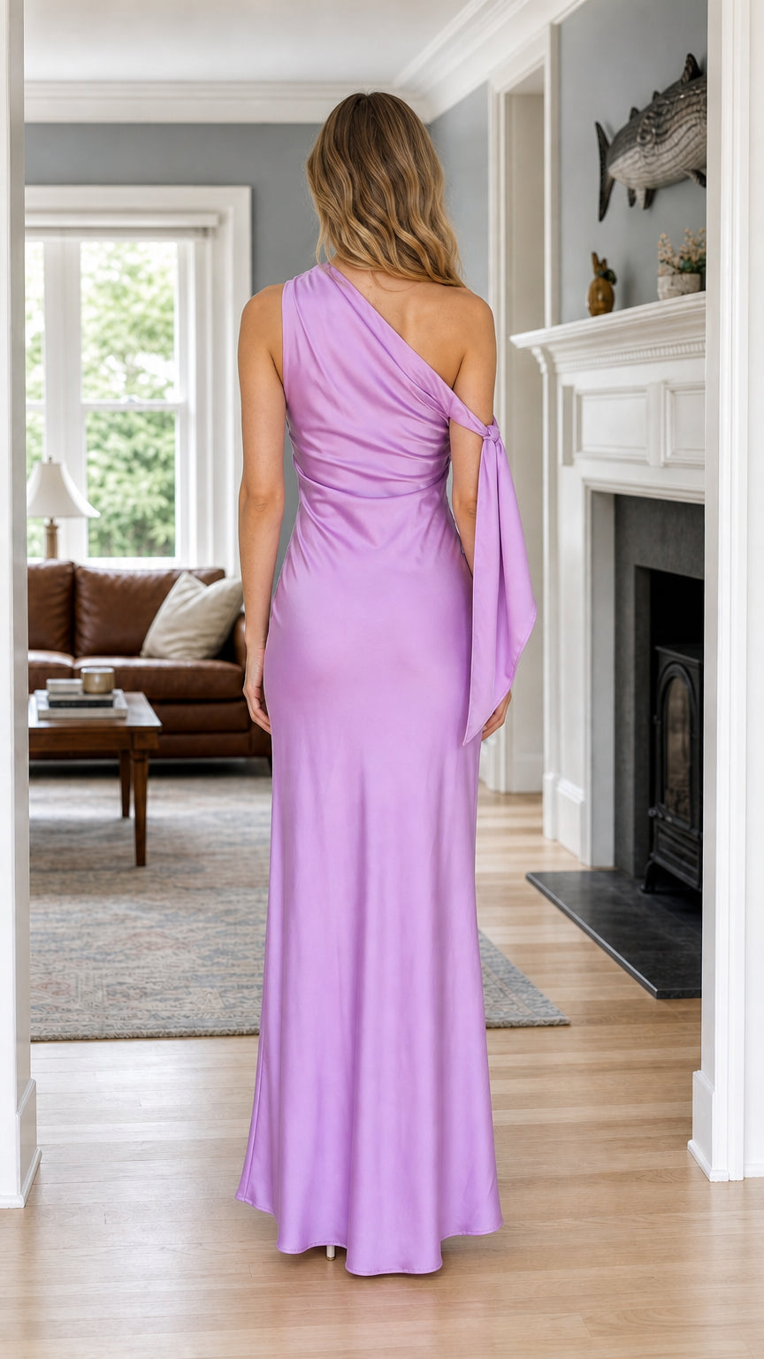Back view of woman wearing lavender one-shoulder ruched satin maxi dress