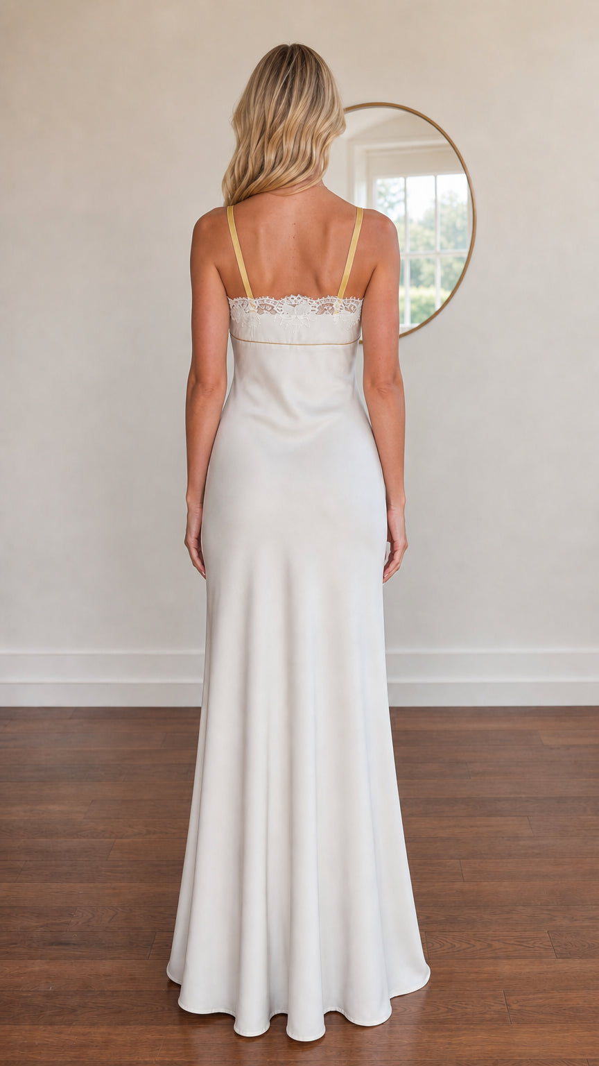 Model wearing white satin evening dress back view showing shoulder straps
