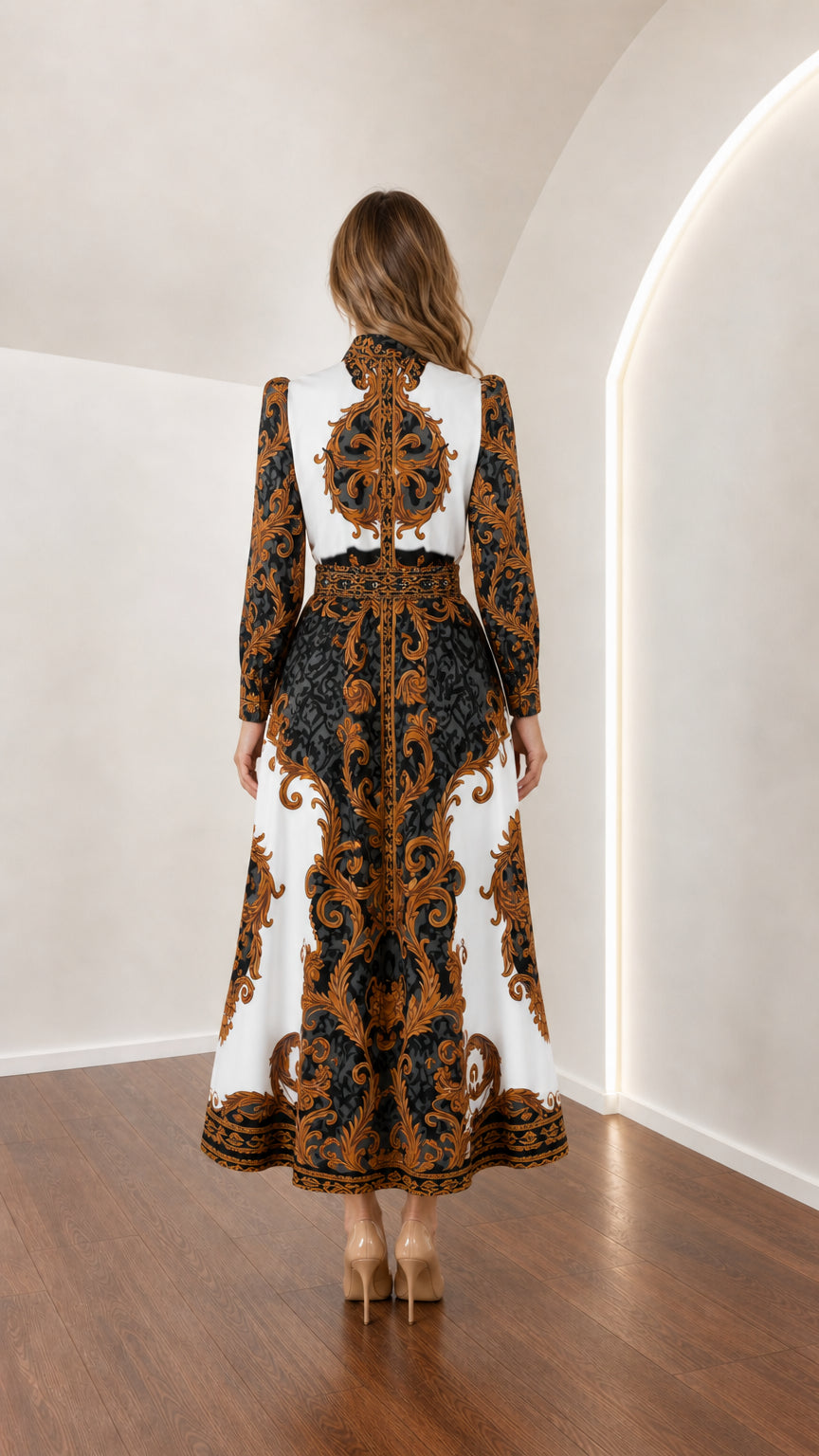 Back view of model in white and gold ornate scroll print maxi dress