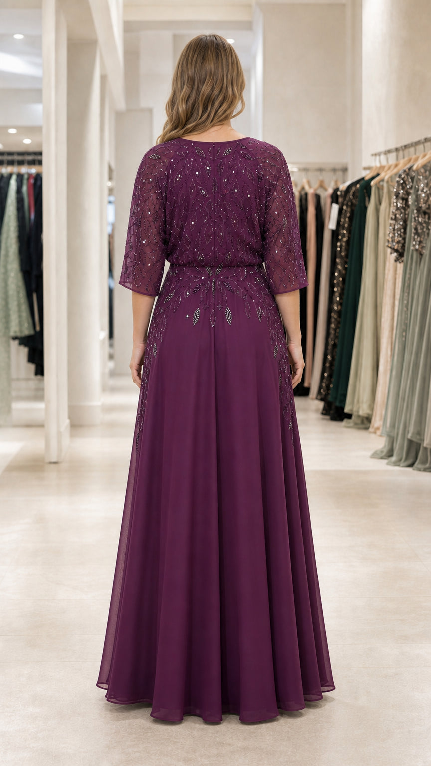 Back view of plum beaded formal gown showing cinched waist and full-length skirt