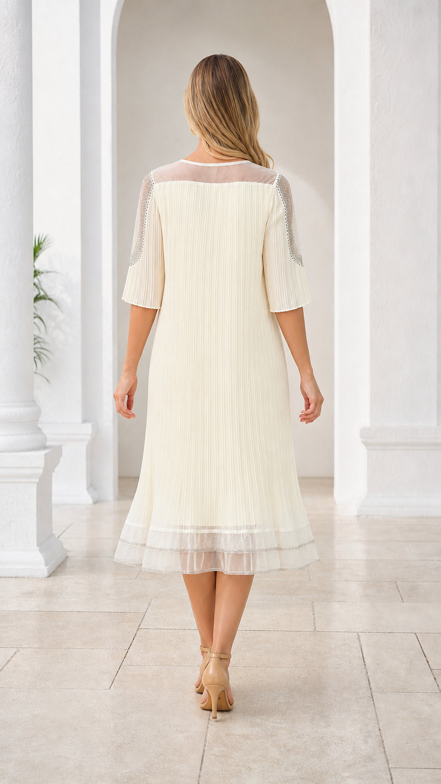 Back view of cream pleated midi dress showing flowing silhouette and hem