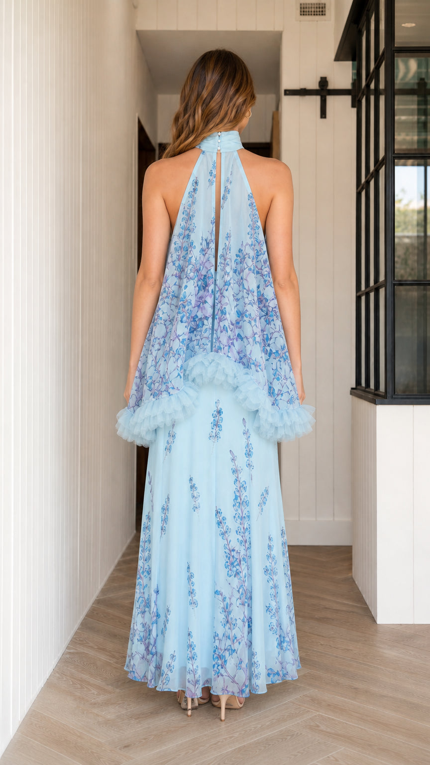 Back view of model in light blue floral halter maxi dress