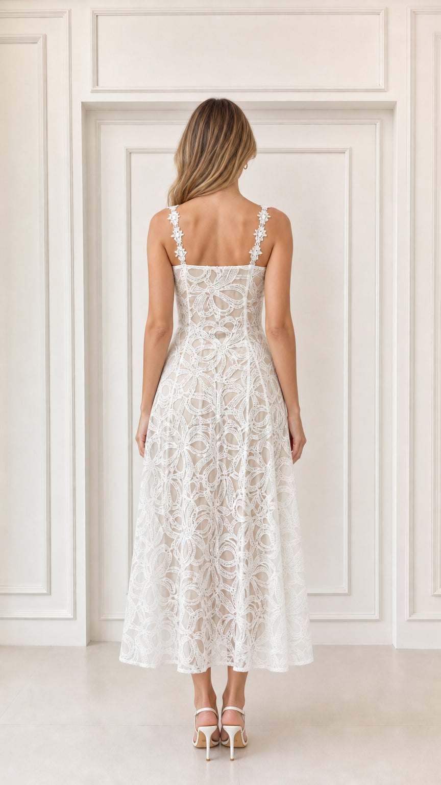 Back view of woman wearing white sleeveless lace midi dress