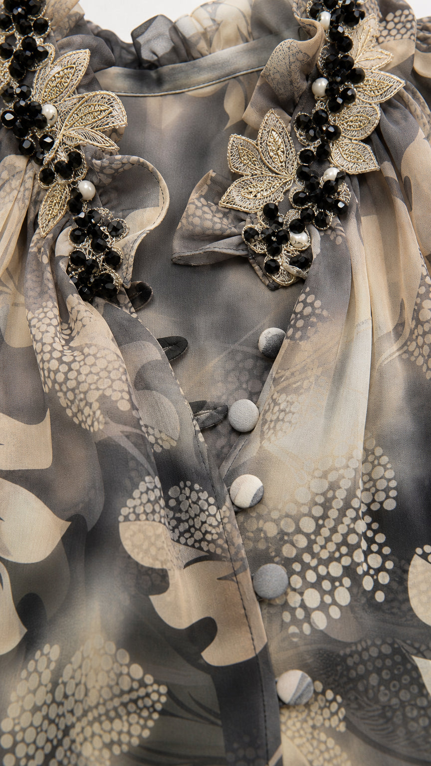 Close-up of 3D beaded floral embellishment and button detailing on neckline