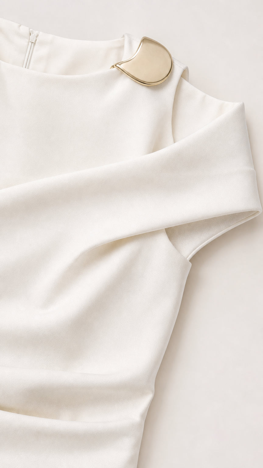 Close-up detail of asymmetrical neckline with gold-tone metal hardware accent