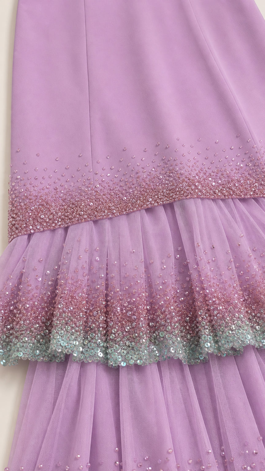Close-up detail of pleated lavender fabric with sparkling ombre sequin trim