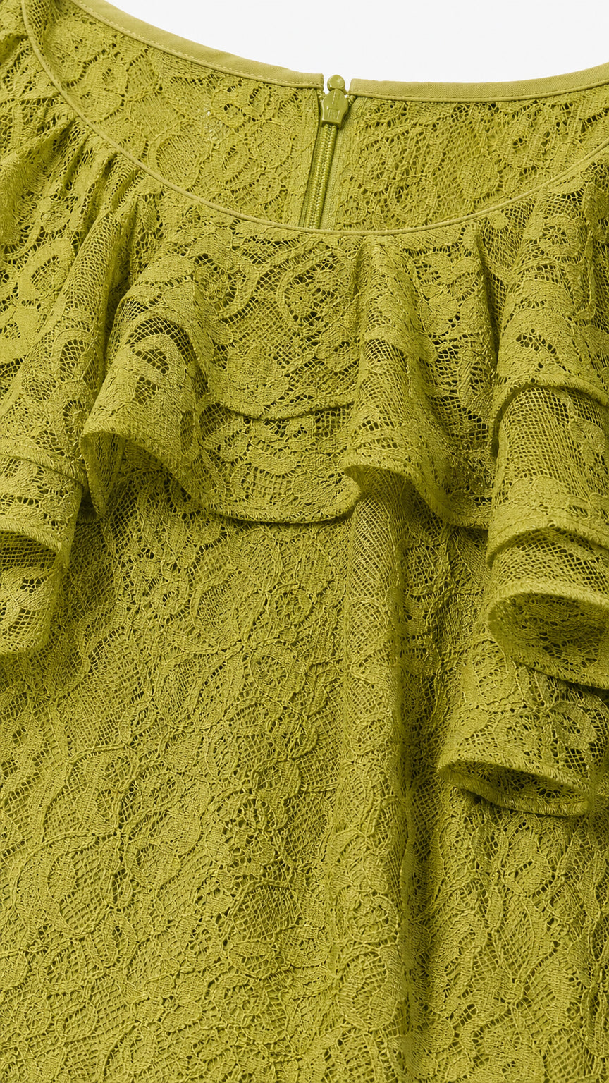 Close-up detail of textured olive green floral lace fabric and back neckline zipper