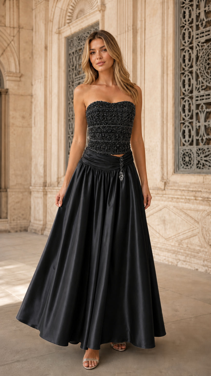 Model wearing black strapless beaded corset satin evening gown