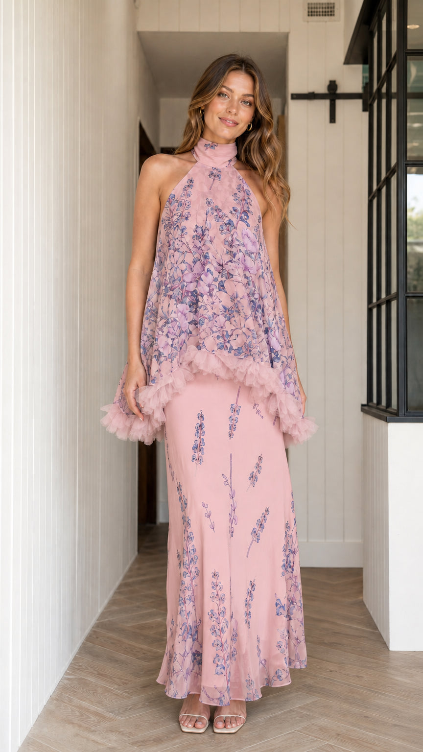 Model wearing dusty pink floral halter maxi dress with ruffle overlay