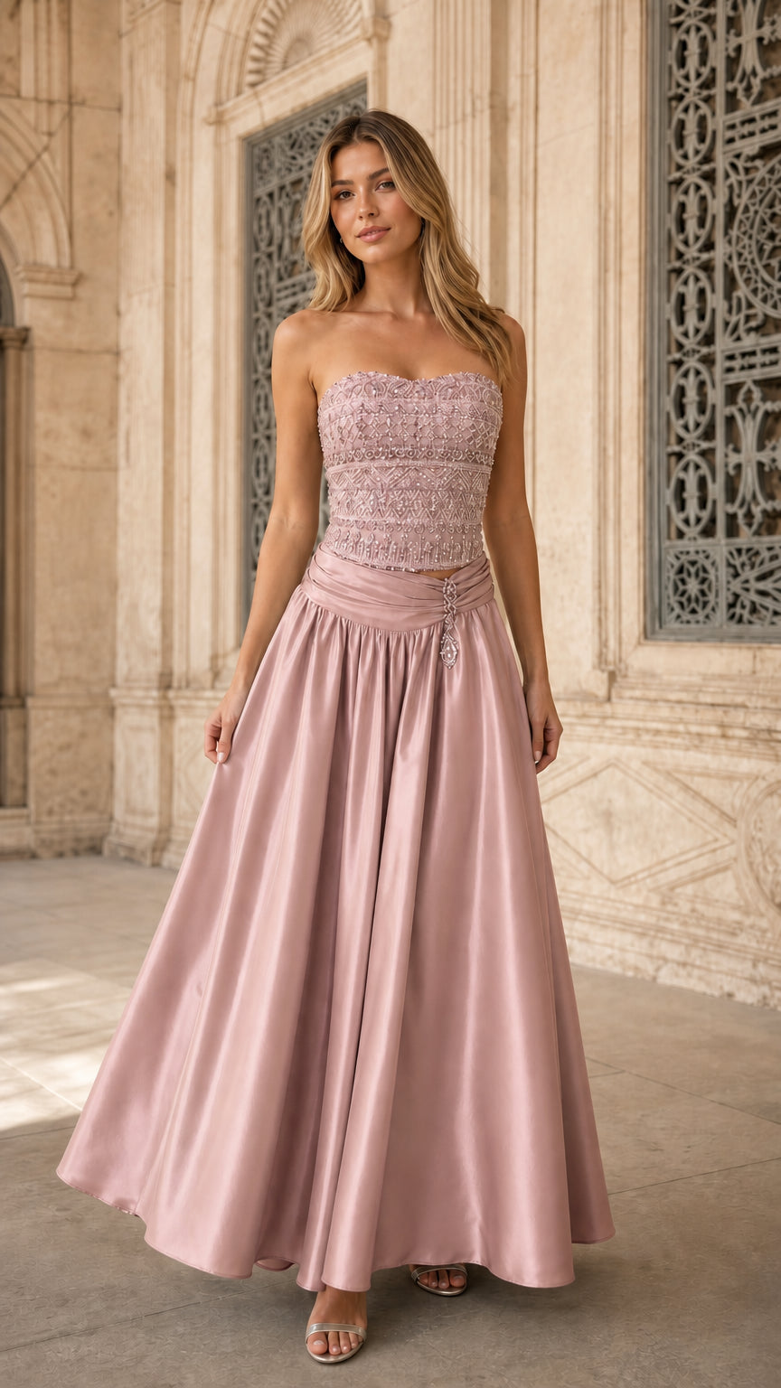 Model wearing dusty rose pink strapless beaded formal maxi dress