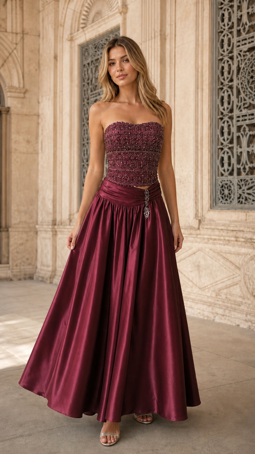 Model wearing rich burgundy wine strapless beaded corset evening gown