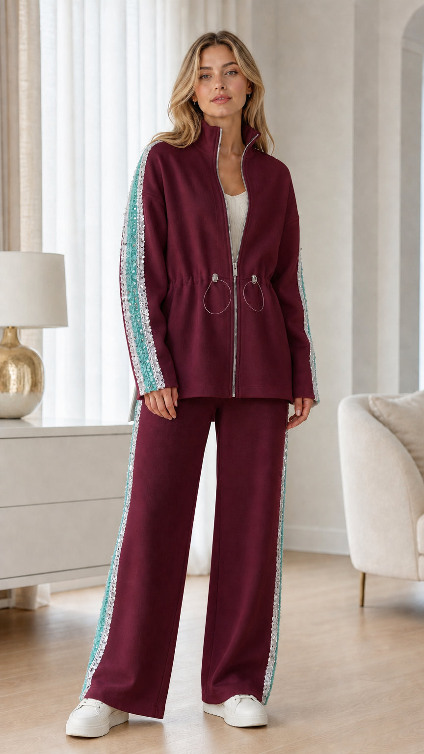 Full-length view of woman wearing burgundy two-piece track set with sequin trim